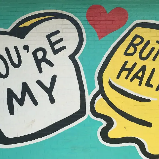 Mural featuring a slice of bread and a pat of butter with playful text